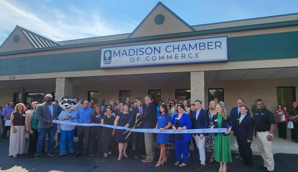 Community and business leaders gather at the Madison Chamber of Commerce ribbon cutting, celebrating growth and local partnerships.