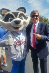 Rep. Dale Strong poses with Sprocket, the Rocket City Trash Pandas mascot.